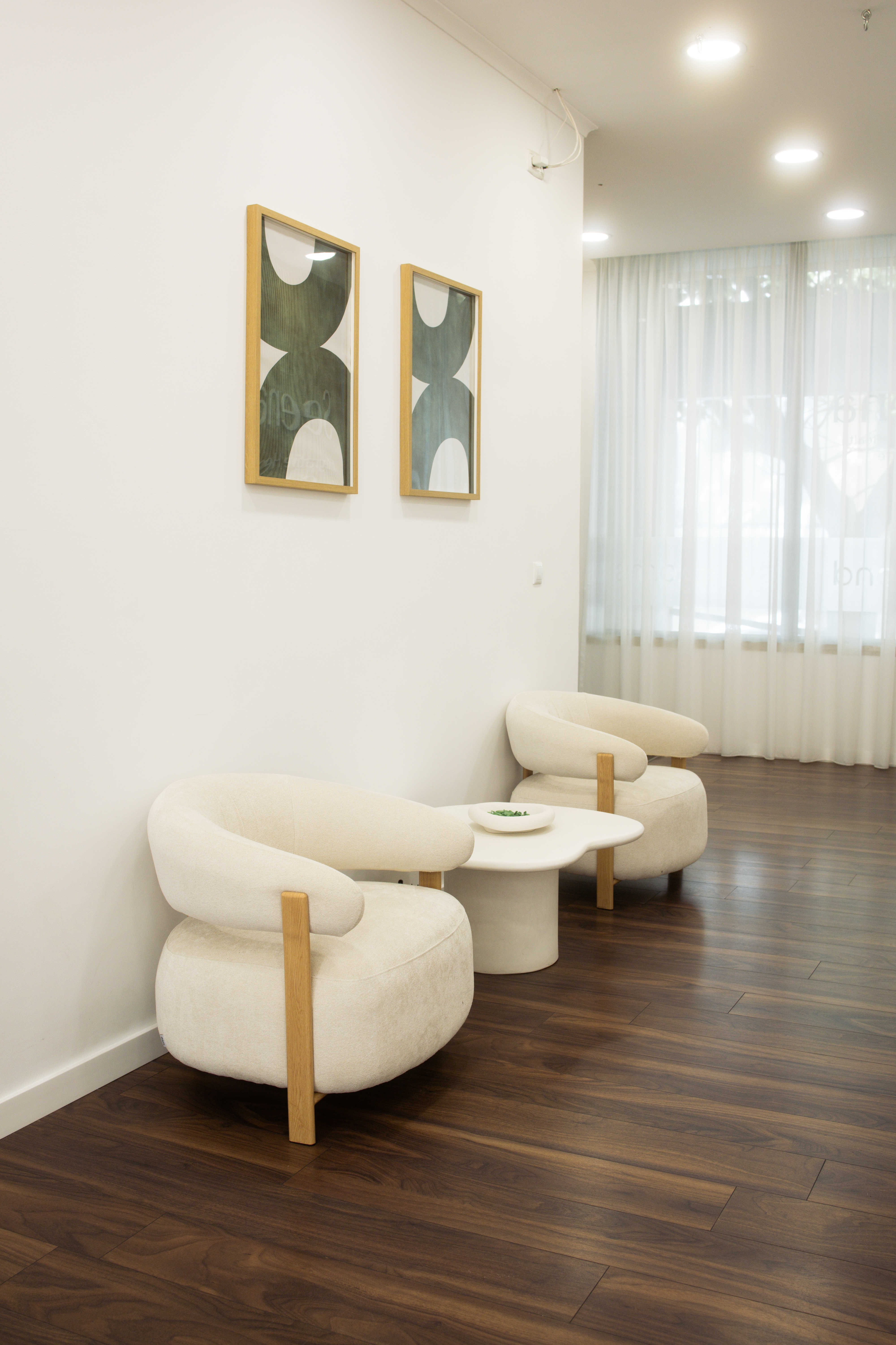 Seena waiting area — white boucle chairs